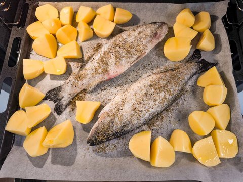 Baking sea bass with potatoes and spices in prague