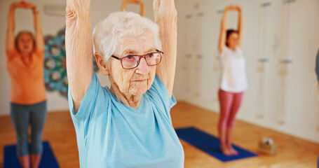 Senior woman, yoga or stretching with class for holistic health, mindfulness or wellness. Elderly,...