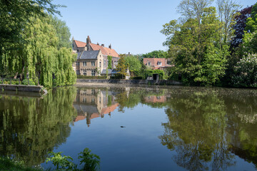 Obraz premium Views of lake and city park with beautiful old buildings in Bruges, Flanders, Belgium, travel destination