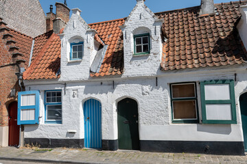 Obraz premium Old medieval houses in narrow streets in central Bruges, Flanders, Belgium, tourists destination in Europe