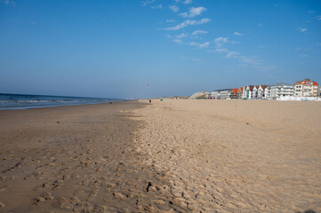 White sandy beach in cosy seaside holiday village on North Sea, built in belle epoque style in Flanders, De Haan or Le Coq sur Mer, Belgium
