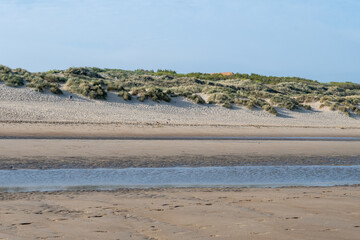 White sandy beach in cosy seaside holiday village on North Sea, built in belle epoque style in Flanders, De Haan or Le Coq sur Mer, Belgium
