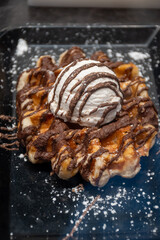 Baked belgian sugar waffles with various toppings, delicious sweet street food in Bruges, Flanders, Belgium