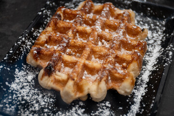 Baked belgian sugar waffles with various toppings, delicious sweet street food in Bruges, Flanders, Belgium