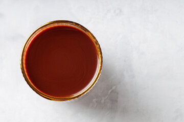 Cocoa Drink in Gold Rimmed Glass on Gray Background, Copy Space, Top View