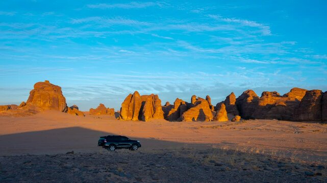 Dramatic sunset-to-sunrise timelapse in the rocky desert landscape of Saudi Arabia, showcasing unique sandstone formations, shifting light, and vibrant sky transitions.