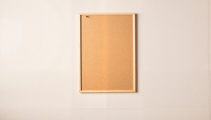 Fototapeta premium Empty corkboard with wooden frame on neutral wall
