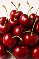 Closeup of Fresh Red Cherries with Stems on Clean White Background
