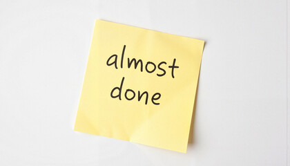 Note with "almost done" message on yellow sticky paper