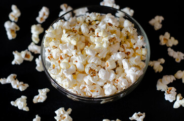 Homemade Salty Popcorn on dark background. Cinema and entertainment concept.