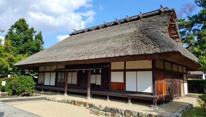 Traditional Japanese Thatched Roof House Surrounded by Nature