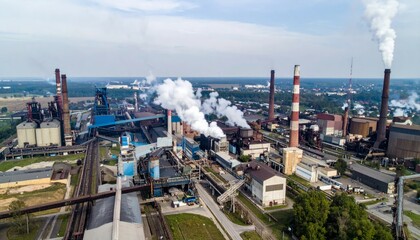 Fototapeta premium Aerial View of Industrial Complex with Smokestacks and Emissions