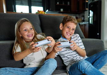 child girl boy brother sister game playing gamer video  console computer joystick together...