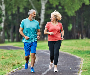woman mature man outdoor running couple sport together jogging healthy mid adult nature fit active exercise fitness run park middle age © Lumos sp
