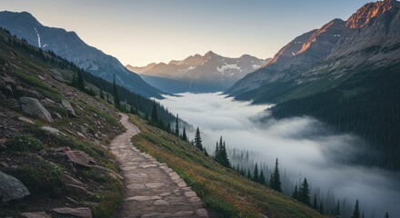 Fototapeta premium Scenic mountain trail with valley fog at sunrise