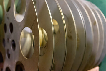 Film reels stacked on a shelf in an old cinema during afternoon light