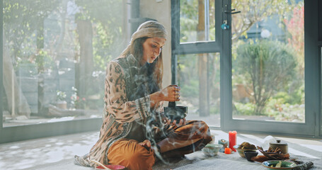 Woman, alternative medicine and meditation with naturopath with sage smoke, ceremony and culture in...