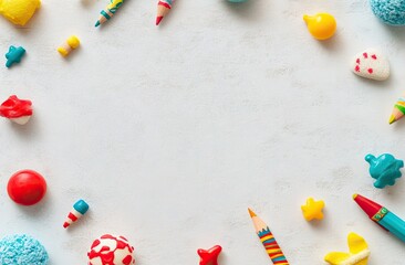 Colorful stationery and candies arranged in a circle, creating a frame on a light background
