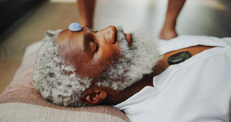 Crystal, zen and healing with man on floor for energy balance, meditation ritual or spirituality....