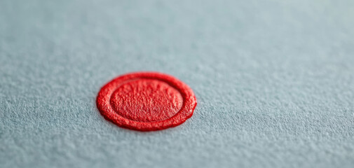 Closeup of legal document featuring red wax seal on textured paper, symbolizing authenticity and formality. vibrant color contrasts with soft background, creating striking visual