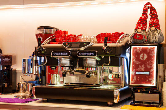 Professional two-group portafilter espresso machine (BFC Galileo) in an Italian bar. Red cappuccino and espresso cups on the hot plate