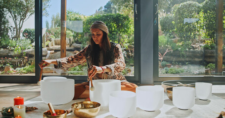 Woman, sound therapy and healing with naturopath with bowls, ceremony and culture in studio. Female...