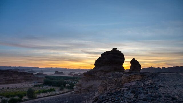 Dramatic sunset-to-sunrise timelapse in the rocky desert landscape of Saudi Arabia, showcasing unique sandstone formations, shifting light, and vibrant sky transitions. Natural geological wonder in th