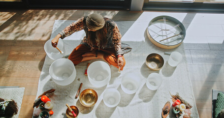 Woman, singing bowl and sound on floor for therapy, frequency or peace with mindfulness at studio....