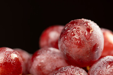 pink ripe grapes after washing the berries, clean wet grapes safe for eating closeup
