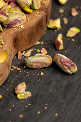 a bunch of green crunchy pistachios cooked with salt for beer and other drinks, side view