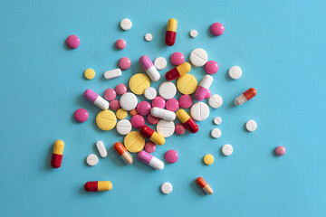 Tablets and pills on a blue background.