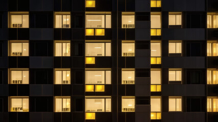 Modern Skyscraper with Glowing Golden Windows in Evening Light