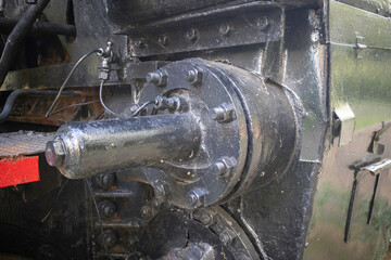 A black train engine with a red stripe on the front