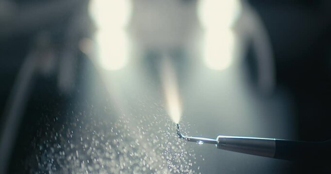 Close-up of triplex with water from dental unit. Close-up of water splashing. Concept of dentistry and dental care. 