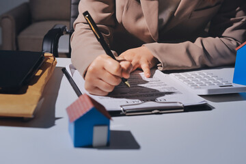Female Real Estate Broker presenting and advised to .model home and building project detail in the...