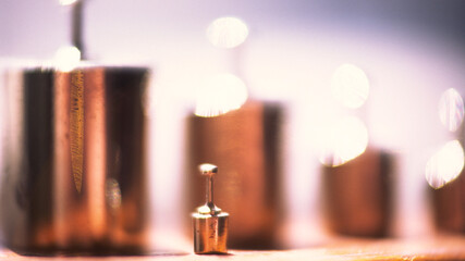 Silhouettes of old standard weights, blurred background.