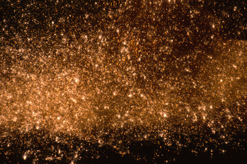 Sparks of molten cast iron on a dark background, blurred background.