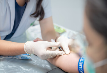 Close up hand of nurse, taking blood sample from a patient in the hospital
