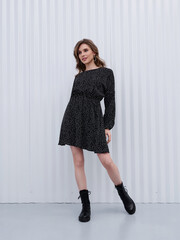 Girl model in stylish clothes posing in studio, fashion photo.