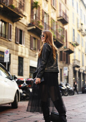 Young stylish girl model walks around the city of Milan.