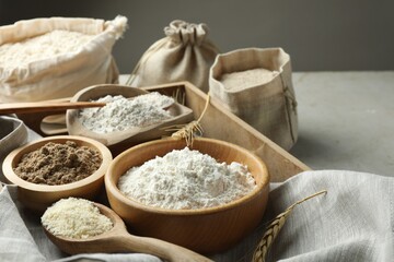 Different types of flour on light table, closeup