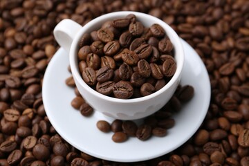 Cup and saucer on coffee beans, closeup