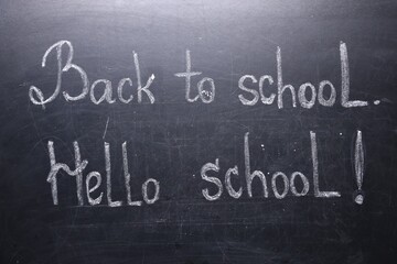 Phrases Back To School and Hello School with exclamation mark on blackboard
