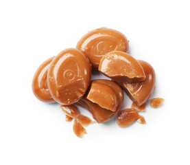 Broken tasty caramel candies isolated on white, top view