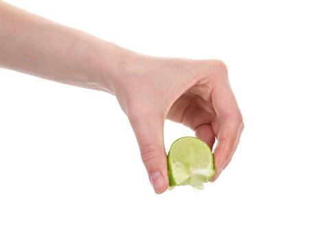 Woman squeezing lime on white background, closeup