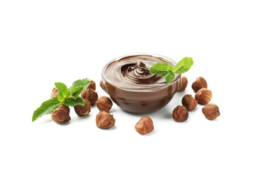 Tasty chocolate spread with mint in bowl and hazelnuts isolated on white