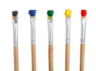 Brushes with different paints isolated on white
