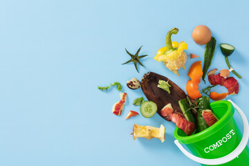 Recycling kitchen waste for natural fertilizer. Green compost bin with vegetable scraps and organic...