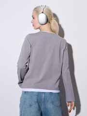 Girl model in stylish clothes posing in studio, fashion photo.
