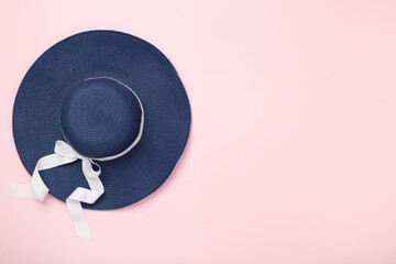 Blue beach hat on color background,top view